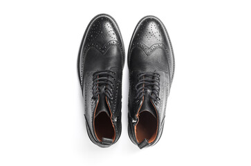 Stylish black leather men's brogue boots isolated on white background. Top view. Flat lay