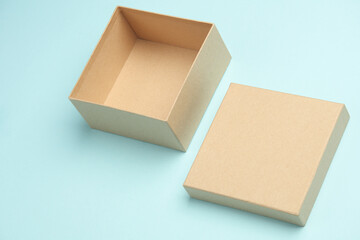 Kraft cardboard box on blue background