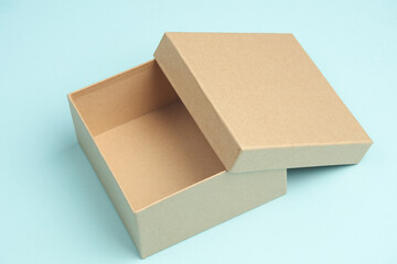Kraft cardboard box on blue background