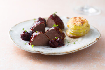 Roasted venison fillet with hot cherries
