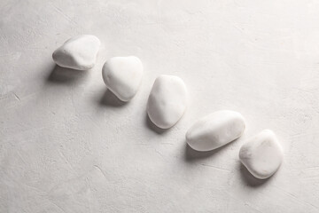 White Pebbles on Concrete Background close up