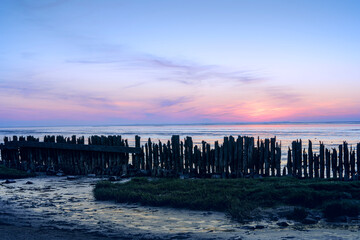 Fototapeta premium Dutch Mud Flats at sunset with Panoramic view over the tidal flats along the shore of the netherlands