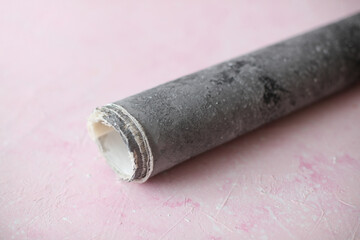 Roll of concrete photo backdrop on pink background