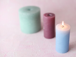 Flaming candle on a pink background. Romantic atmosphere