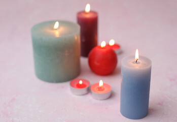 Flaming candles on a pink background. Romantic atmosphere