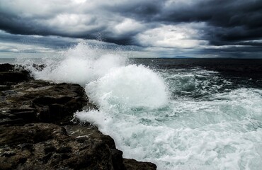 The waves hit the rocks, with several different views, symbolizing the never-ending spirit. World Oceans Day, Wave power energy, green energy