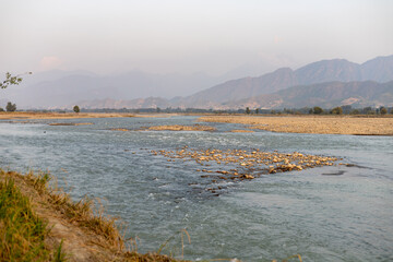 Serene River Flowing through Mountainous Swat Valley in Pakistan