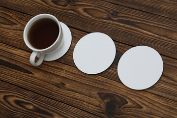 White round empty coasters Mockup and coffee cup on wooden background