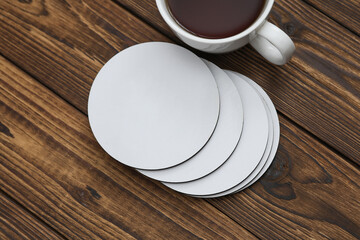 White round empty coasters Mockup and coffee cup on wooden background