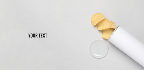 White tube of potato chips on a gray background. Mock up for template design. Space for text