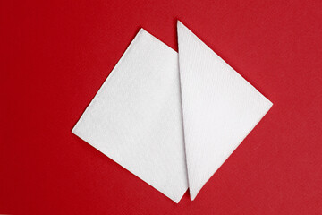 White paper napkins on a red background. Top view