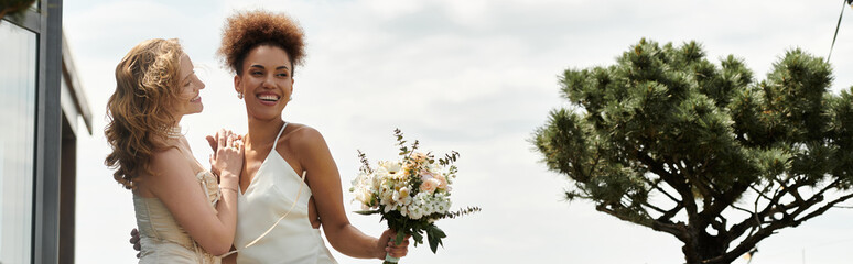 A lesbian couple beams with joy on their wedding day.