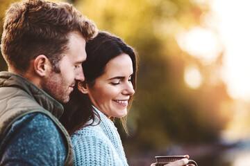 Couple, hug and smile with coffee in nature, bokeh and relax in countryside for honeymoon and morning. Outdoor, man and woman with embrace, peace and love in Oklahoma, travel and cup of tea in date