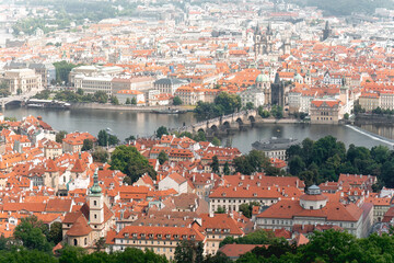Obraz premium Aerial view of Prague's cityscape, showcasing its traditional architecture and the iconic Charles Bridge spanning the Vltava river