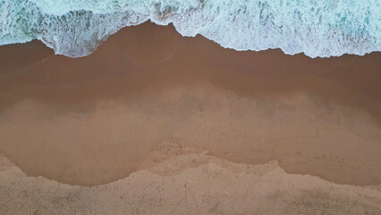 Foamy waves rolling sand empty shoreline aerial view. Wonderful turquoise sea