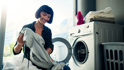 Washing machine, laundry and happy woman cleaning fabric in home for hygiene or housekeeping. Chores, dryer and person load clothes in electrical appliance for housework or fresh textile in basket