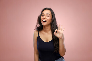 An Incredible Woman Smiling And Showing Ok Sign
