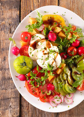 summer mixed vegetable salad with colored various tomatoes, radish and mozzarella