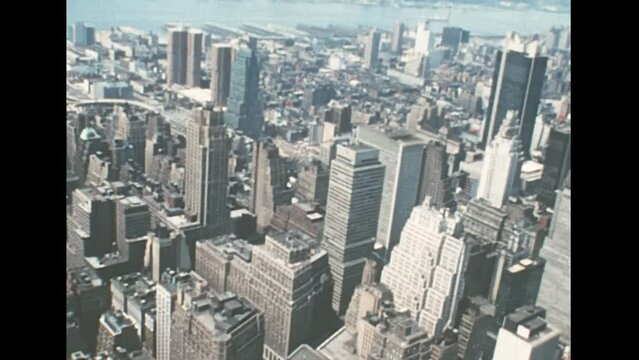 New York, Midtown Manhattan, United States America 1976: Herald square and Macy's store of New York with historic buildings and road traffic. Archival skyline of New York with on East river in 1970s.