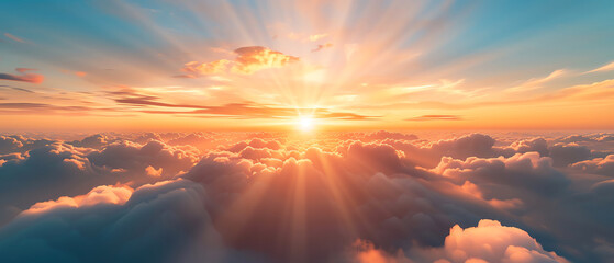 Obraz premium Breathtaking sunrise over fluffy clouds fills the sky with vibrant colors and warmth, offering a serene and inspiring start to the day.