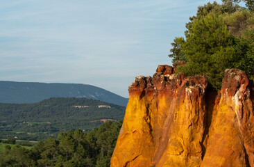View of ochre cliffs and surrounding landscape, photographed from the historic town of Roussillon,...