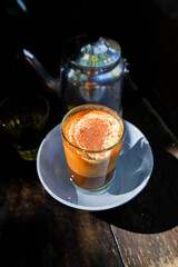 close up, a glass of Vietnamsese egg milk coffee under morning light, traditional 