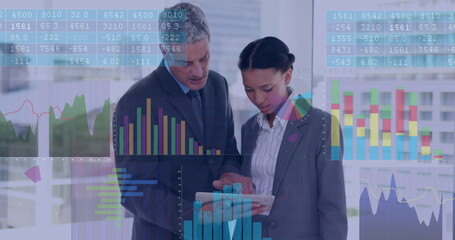 Image of data processing over diverse businessman and businesswoman discussing at office