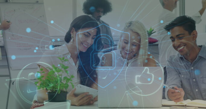 Image of computer icons, padlock in shield over diverse coworkers sharing ideas in office - Powered by Adobe