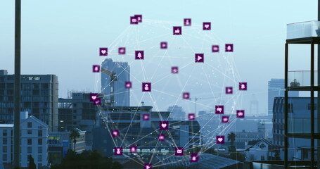 Image of globe of digital icons spinning against aerial view of cityscape