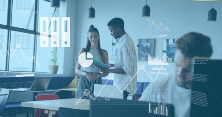 Image of graphs, map, cloud in laptop over diverse coworkers discussing reports in office