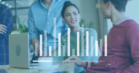 Image of graph and loading bars over diverse coworkers discussing reports in office