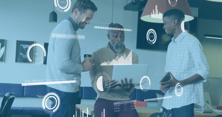 Image of multiple graphs, loading bars and circles, diverse coworkers sharing ideas in office