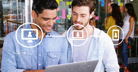 Image of flowchart and connected dots over diverse coworkers sharing ideas on laptop