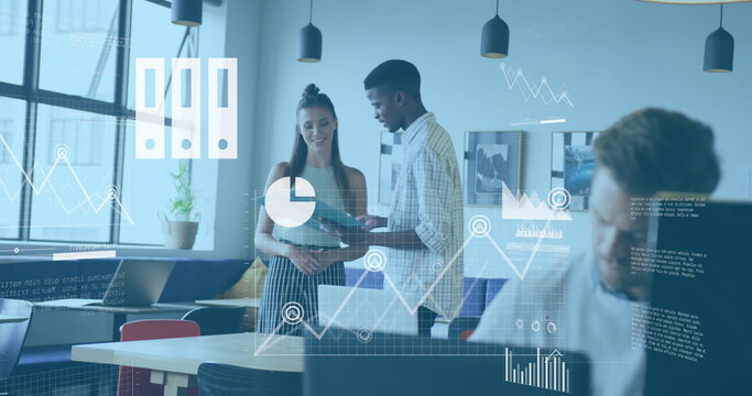 Image of graphs, map, cloud in laptop over diverse coworkers discussing reports in office - Powered by Adobe