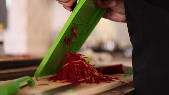 Hands Using A Julienne Slicer To Cut Carrots Into Thin Strips.