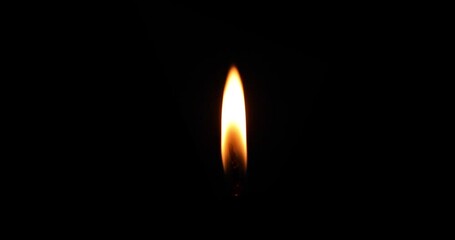 Close-up of a brightly lit candle flame on a dark background. - Powered by Adobe