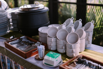 Iron pot for serving soup, paired with bowls and spoons, ready for a hearty meal.