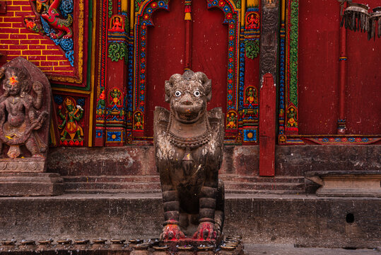 The guardian Bird statue in front of red wall at Hindu Temple of Changu Narayan, UNESCO World Heritage Site, Changunarayan, Kathmandu Valley, Nepal, Asia