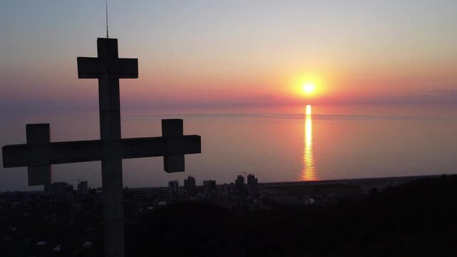 Cross with a sunset background, Gonio Georgia, Black Sea, beautiful sunset over the sea