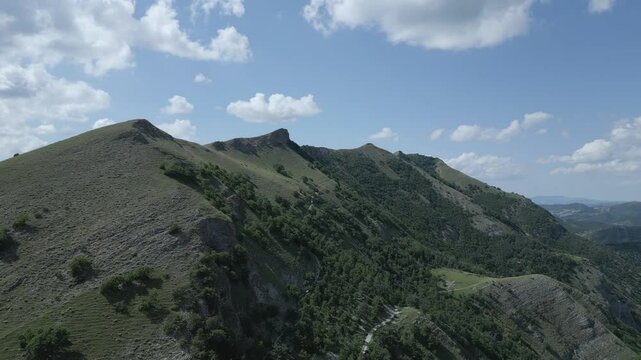 Soar above the majestic Italian mountains with this stunning drone footage. Enjoy breathtaking views of rugged peaks, lush valleys, and pristine natural beauty from a bird's-eye perspective. Nerone