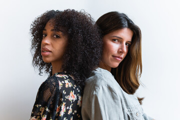 Portrait of two cheerful young women standing together
