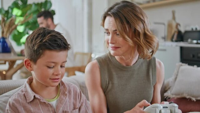 Mother son gaming console at morning home closeup. Cheerful mom child playing