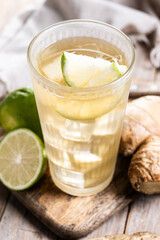 Fresh ginger ale drink in tall glass on wooden table