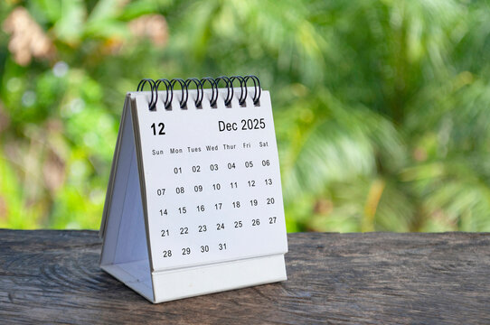 December 2025 white table calendar with outdoor background. Calendar concept