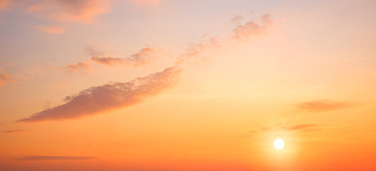 Sunrise sky in the morning with colorful yellow sunlight and cloud on panoramic orange sunset sky background in golden hour time