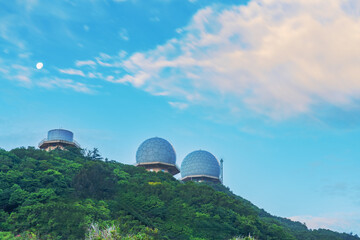 The high mountains covered with green forests and the blue sky floating with clouds in Zhejiang Province, China