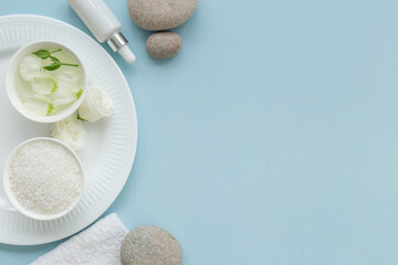 White roses and stones with skin care cosmetics products. Mock up, top view