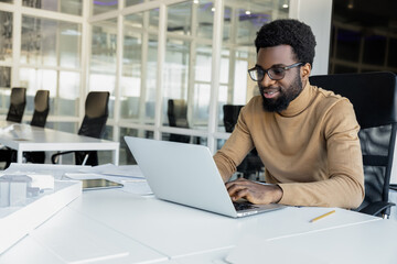 African american young man working in the office and looking busy