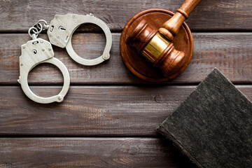 Police metal handcuffs with criminal code book and judges gavel. Law and justice concept