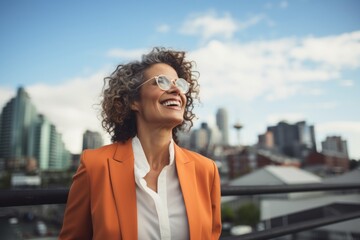 Portrait of a happy woman in her 50s dressed in a stylish blazer in front of vibrant city skyline
